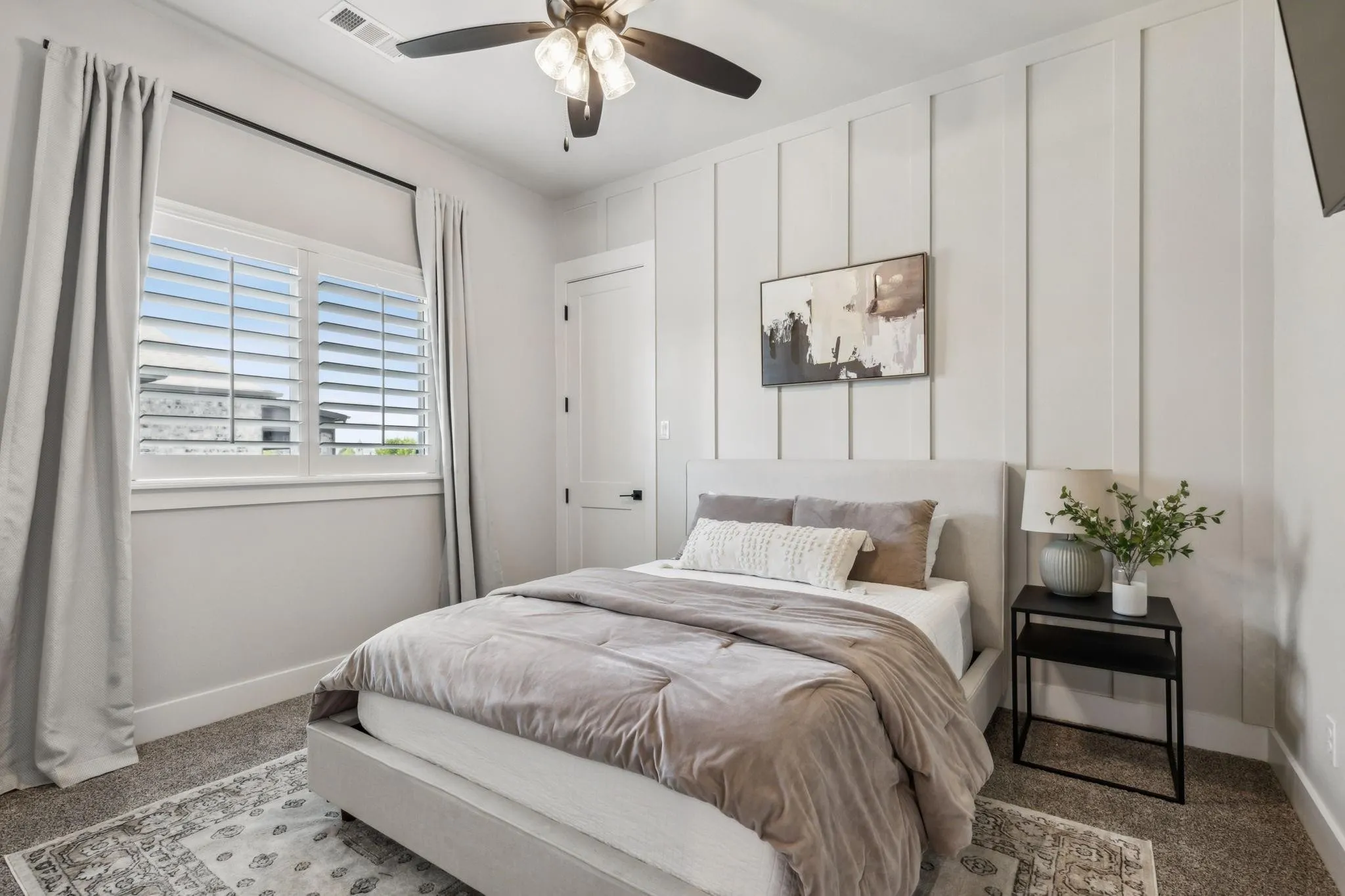 tylish guest bedroom in Mike DePriest’s Northlake, TX home, featuring a modern feature wall, neutral tones, and a cozy, inviting atmosphere.