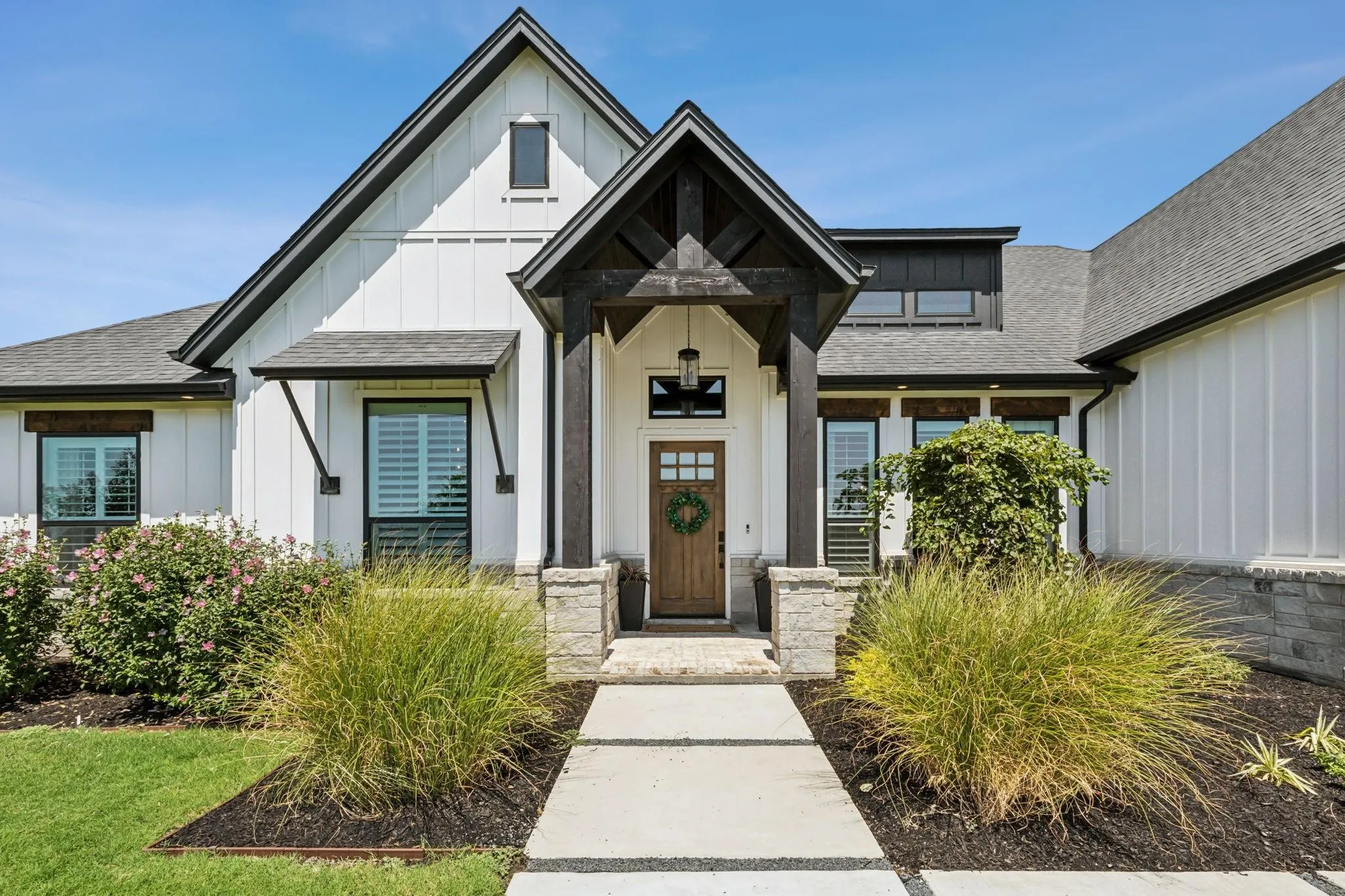 Inviting front entrance of Mike DePriest’s Northlake, TX home, featuring a stylish front door framed by lush foliage and elegant landscaping.
